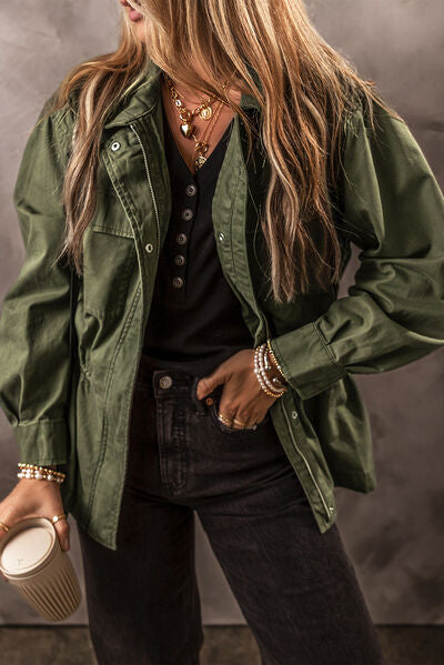 A denim jacket in army green colour with a cinch waist detail.