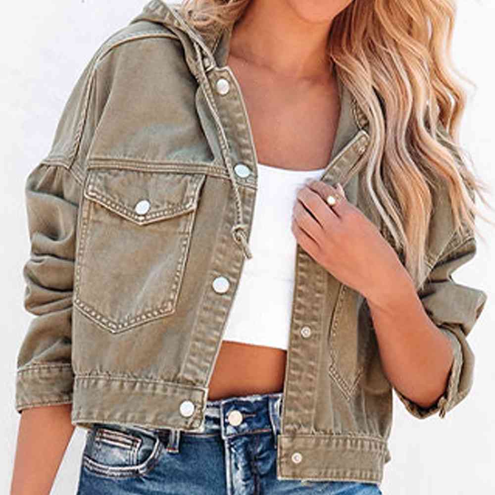 A stylish camel colour hooded denim jacket with a button up front, flap pockets and adjustable drawstring hood. The Jacket features a relaxed fit with rolled-up sleeves, paired with a white crop top and blue jeans for a casual trendy look.